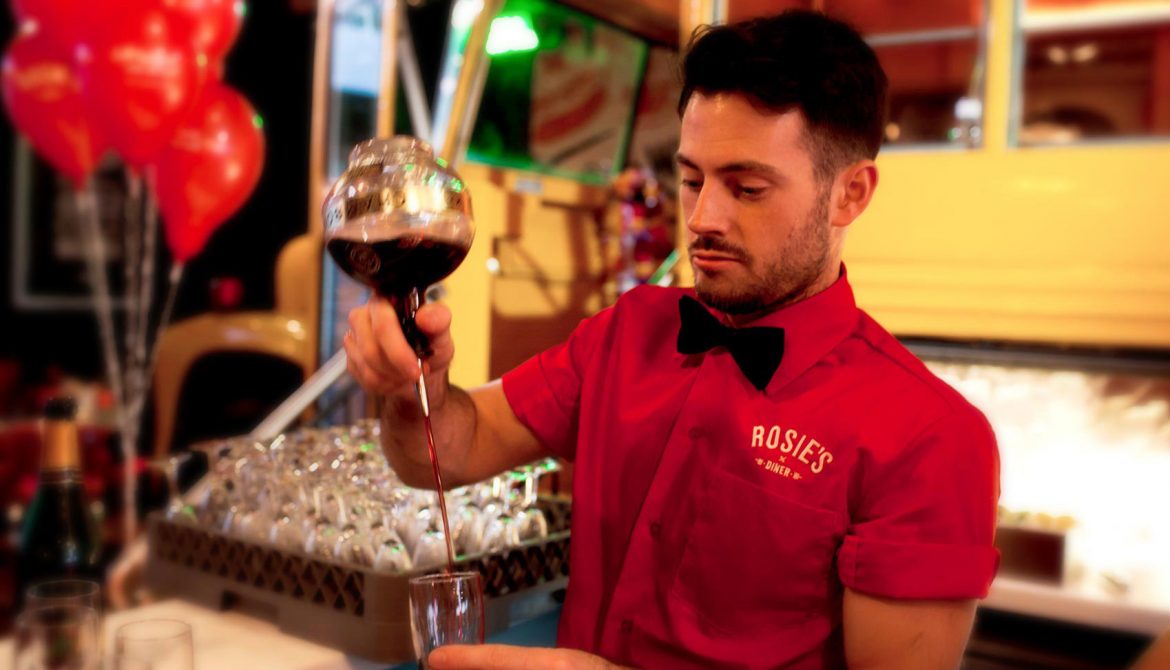 One of Rosie's Diner Staff pouring drinks